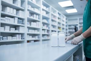 Unbranded tablet bottles of a new blood pressure drug in a UK NHS hospital pharmacy dispensary